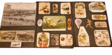 An early 20th century scrap album, inscribed Xmas 1921 from Grandad, with postcards, cuttings, etc