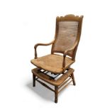 An early 20th century beech American Rocking chair, rattan seat and back, 110cm high