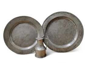 An 18th century pewter charger, 46.5cm diam, London touch marks; another, 42cm diam;  a French