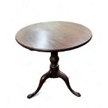 A George III mahogany one piece tilt top table, turned supports, tripod base, pad feet.72cm high,