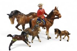 A Japanese model, Canadian Mountie Policeman on bay horse, gloss, , 20.5cm high, model no 8080,