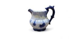 A Royal Crown Derby milk jug, in the manner of W.E.J. Dean, decorated with a continuous scene of