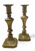 A pair of 19th century brass ejector candlesticks, reel shaped sconces, 21cm high, c.1850