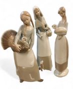 A Lladro figure, of a girl holding a turkey, 27cm high, printed mark;  others, girl holding a lamb;