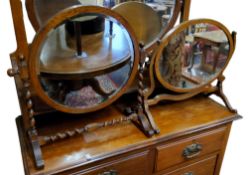 An early 20th century oak circular dressing table mirror with barley twist supports and stretcher