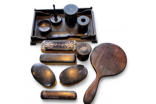 An early 20th century ebonised dressing table set, comprising brushes, ring tree, cylindrical