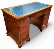 An reproduction yew wood pedestal kneehole desk, by Iain James Furniture, teal tooled leather inlaid