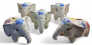 Five Arthur Wood money banks, in the form of comical elephants, painted in colours with stylised