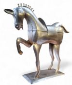 A decorative hammered metal sculpture of a prancing stallion, 48cm x 54cm