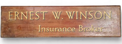 An early 20th century sign written mahogany plaque advertising 'Ernest W. Winson Insurance