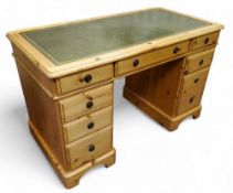A modern pine twin pedestal kneehole desk with club house green tooled leather writing surface, 77cm