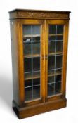 An Old Charm type golden oak astrigal glazed bookcase, 137cm x 75cm x 39cm