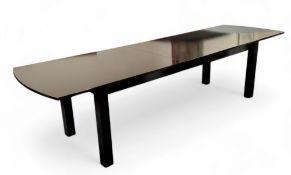 A substantial contemporary draw leaf dining table, over 10ft in length, ebonised stile legs, 77cm