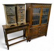 An Old Charm type astrigal glazed bookcase, linen fold details; a pair of Aboriginal inspired