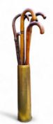 A large WWI artillery shell; six walking sticks (7)