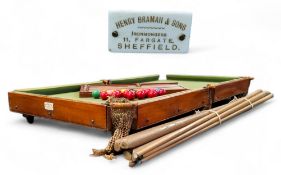 A Henry Bramah & Sons of Sheffield table top slate bed billiards table, with score board, cues, etc,