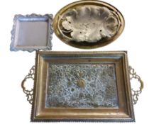 A large Persian two handled brass tray, the field heavily embossed with stylised flowers and