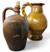 A 20th century stoneware ewer, incised in with lines and dots, twisted handle, 30cm high;