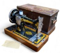 A cased Singer sewing machine with key
