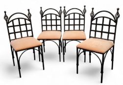 A set of four ebonised wrought iron chairs, open twisted finials, lattice workbook splat, arched