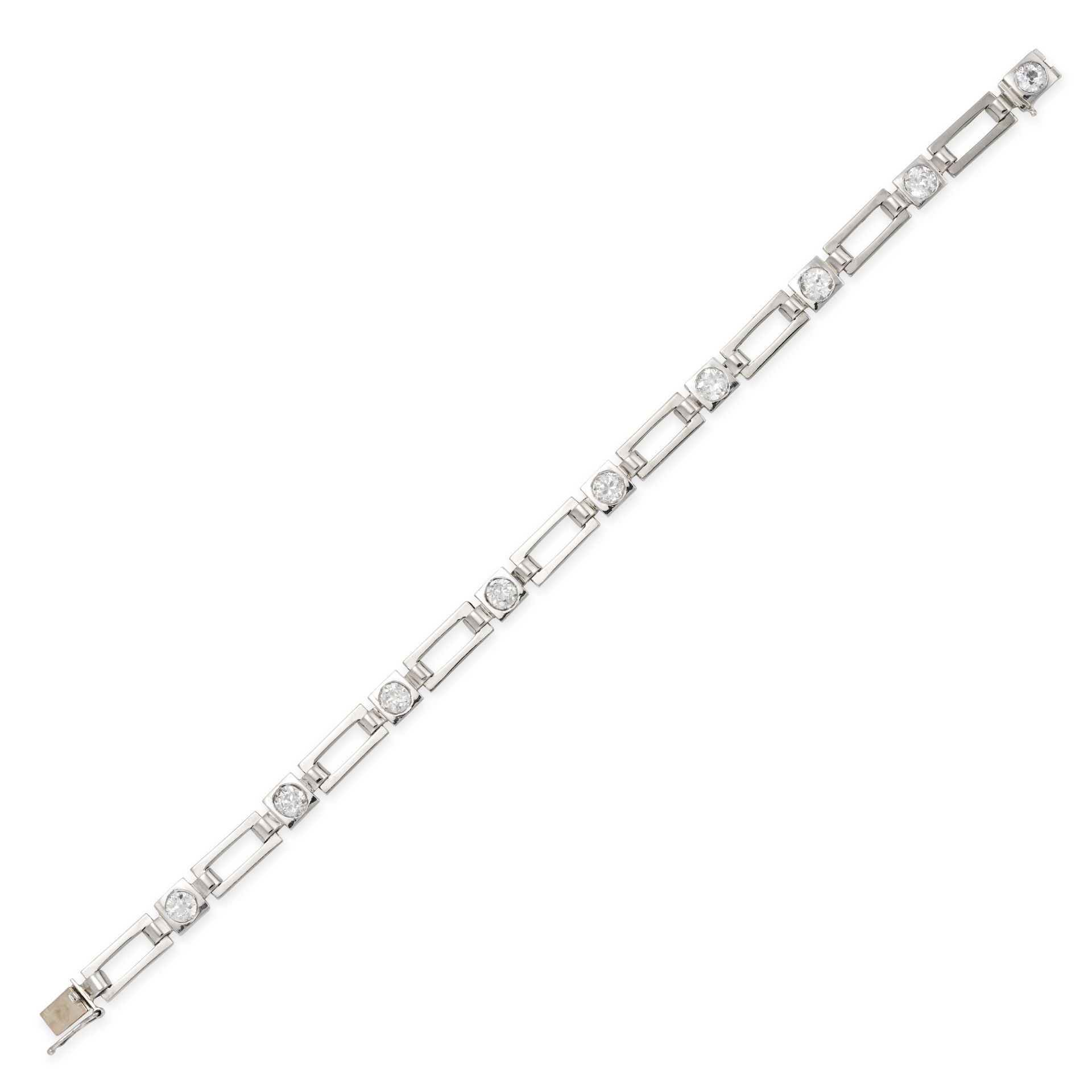 A DIAMOND BRACELET in 14ct white gold, comprising a row of openwork links accented by old Europea...