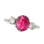 A RUBY AND DIAMOND THREE STONE RING in platinum, set with an oval cut ruby of approximately 3.28 ...