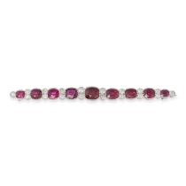 A RUBY, SPINEL AND DIAMOND BAR BROOCH in white gold, set with a graduating row of cushion cut rub...