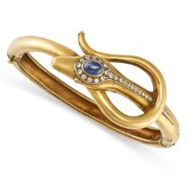 A SAPPHIRE AND DIAMOND SNAKE BANGLE in 18ct yellow gold, designed as a snake coiled around itself...