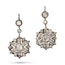 A FINE PAIR OF ANTIQUE DIAMOND STAR DROP EARRINGS in silver, each comprising a row of old cut dia...