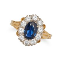 A SAPPHIRE AND DIAMOND CLUSTER RING in 18ct yellow gold, set with an oval cut sapphire in a clust...