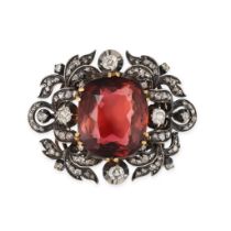 AN ANTIQUE PINK TOURMALINE AND DIAMOND BROOCH in yellow gold and silver, set with a cushion cut p...