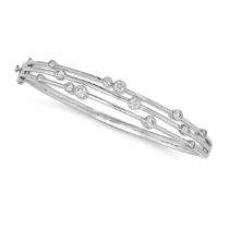 A DIAMOND BUBBLE BANGLE in 18ct white gold, the hinged openwork bangle set with three rows of rou...