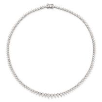 A DIAMOND LINE NECKLACE in platinum and 18ct gold, formed of a series of graduated drop shaped li...