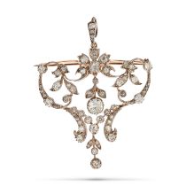 AN ANTIQUE DIAMOND BROOCH / PENDANT in yellow gold and platinum, in scrolling foliate design set ...