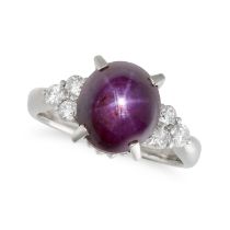 A STAR RUBY AND DIAMOND RING in platinum, set with a cabochon star ruby of 8.23 carats, the shoul...