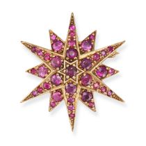 A VINTAGE RUBY STAR BROOCH / PENDANT in 9ct yellow gold, designed as a twelve rayed star set thro...