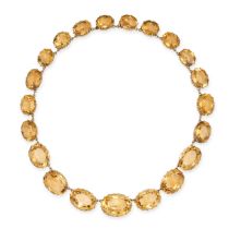 AN ANTIQUE CITRINE RIVIERE NECKLACE in yellow gold, comprising a row of graduating oval cut citri...