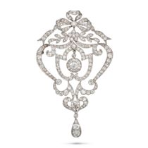 A DIAMOND BROOCH / PENDANT in white gold, the openwork scrolling pendant surmounted by a bow, sus...