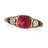 AN ANTIQUE GARNET AND DIAMOND RING in yellow gold and silver, set with a cushion cut garnet betwe...