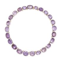 AN ANTIQUE AMETHYST RIVIERE NECKLACE in yellow gold, comprising a row of oval cut amethysts, no a...