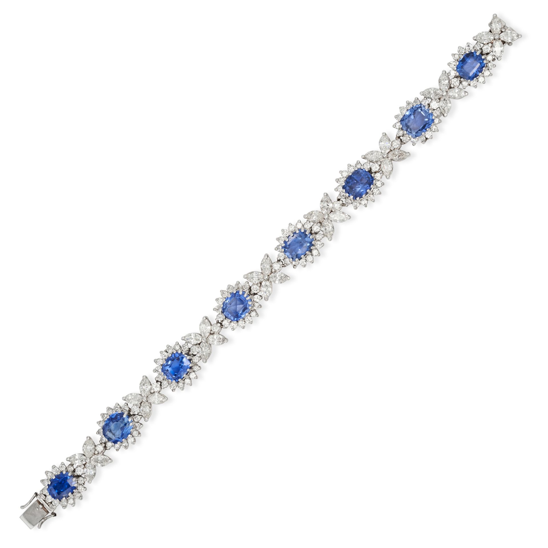 A CEYLON NO HEAT SAPPHIRE AND DIAMOND CLUSTER BRACELET in white gold, comprising a row of cushion...