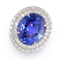 A TANZANITE AND DIAMOND CLUSTER RING in 18ct white gold, set with an oval cut tanzanite of 16.33 ...