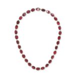 AN ANTIQUE GARNET RIVIERE NECKLACE in 9ct yellow gold, comprising a single row of oval cut cut ga...