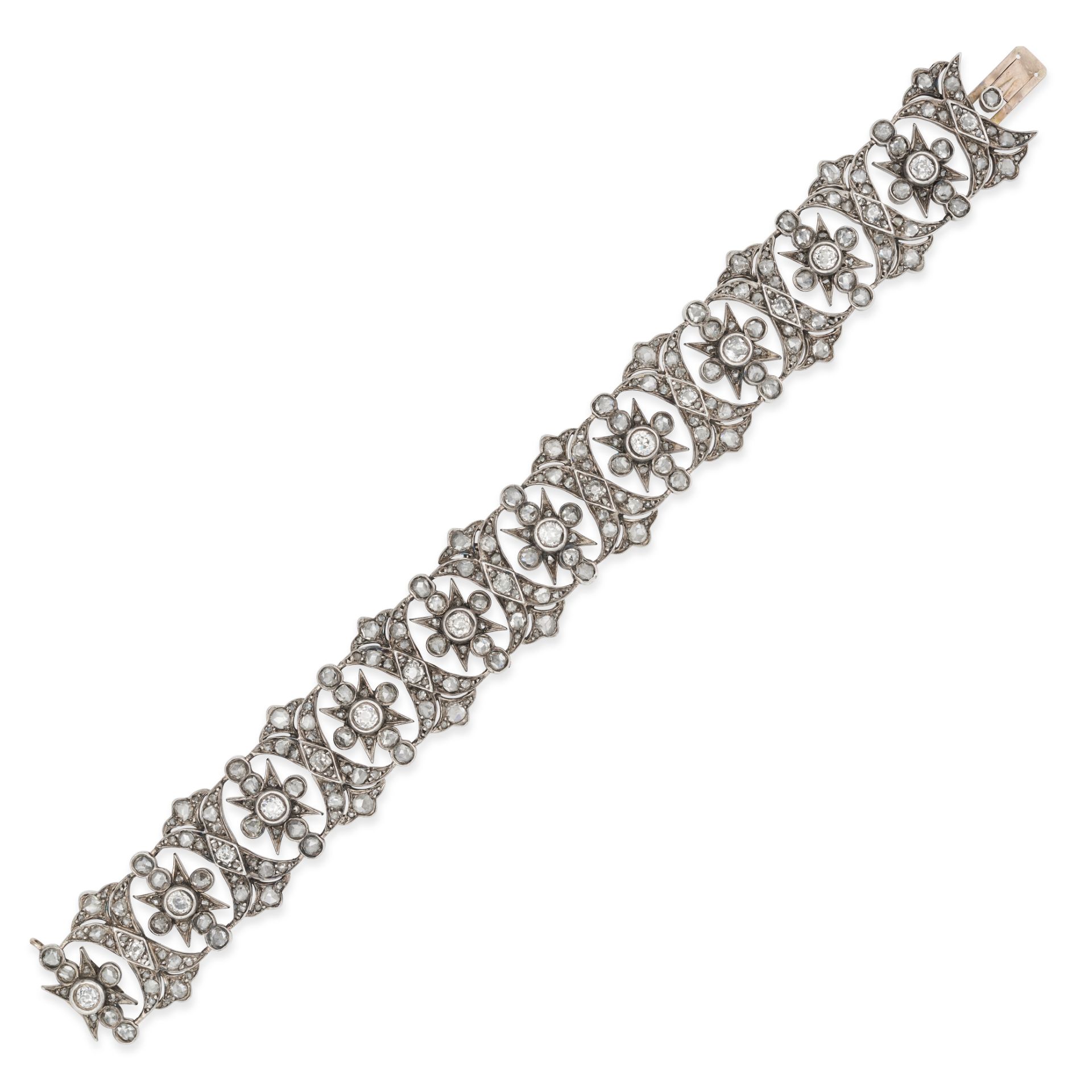 A DIAMOND BRACELET in yellow gold and silver, the openwork bracelet set throughout with old and r...