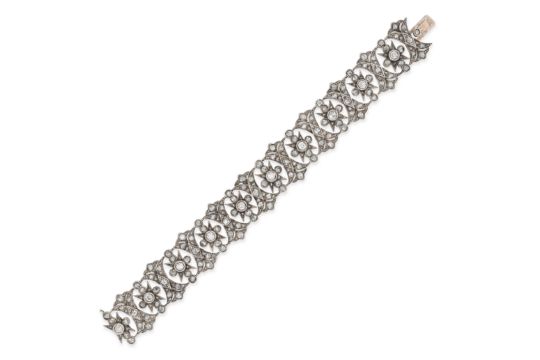 A DIAMOND BRACELET in yellow gold and silver, the openwork bracelet set throughout with old and r...