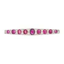 A RUBY AND DIAMOND BAR BROOCH in white gold, set with a row of oval cut rubies, accented by pairs...