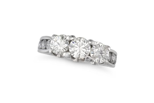 A DIAMOND DRESS RING in 14ct white gold, set with three round brilliant cut diamonds weighing app...