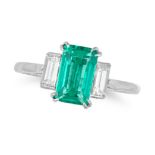A COLOMBIAN EMERALD AND DIAMOND THREE STONE RING in platinum, set with an octagonal step cut of 1...
