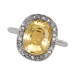 A CEYLON NO HEAT YELLOW SAPPHIRE AND DIAMOND RING in 18ct white gold, set with a cushion cut yell...