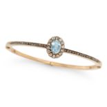 AN ANTIQUE AQUAMARINE AND DIAMOND BANGLE in yellow gold, the hinged bangle set with an oval cut a...